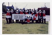 U.S. Coast Guard Auxiliary safety mascots standing near a sign